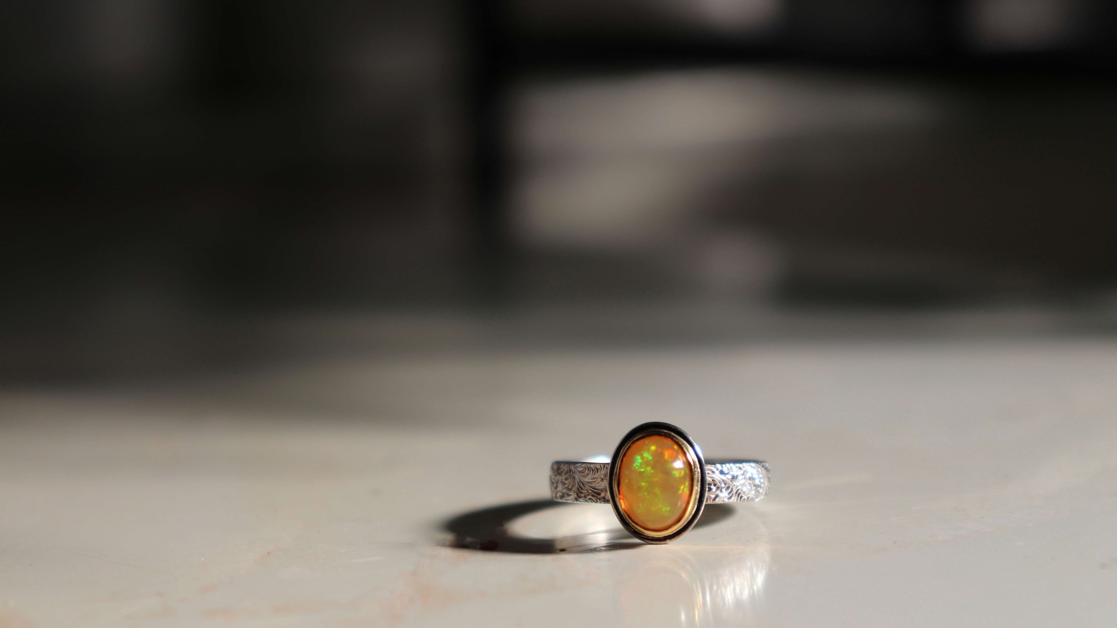 Ethiopian Opal Ring in Silver and Gold glowing in the sun
